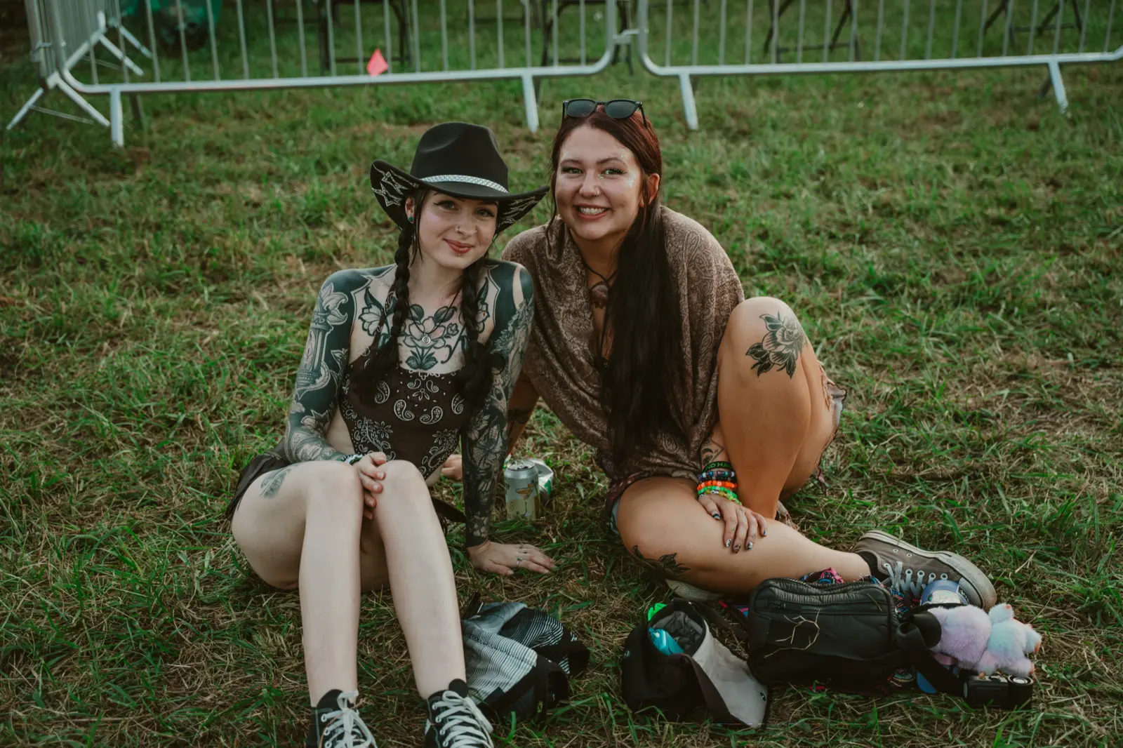Two people sitting on the grass at Sound Haven